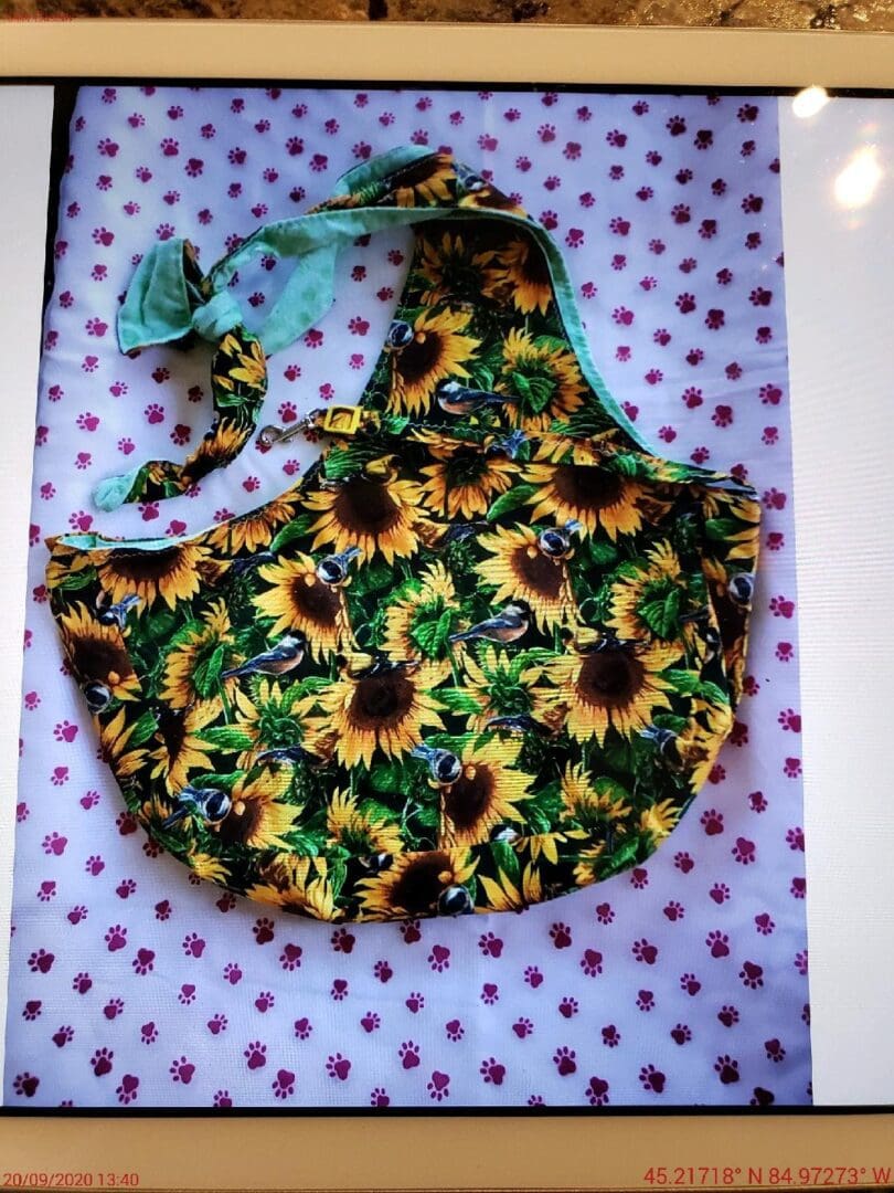 A bag with sunflowers on it sitting on top of a table.