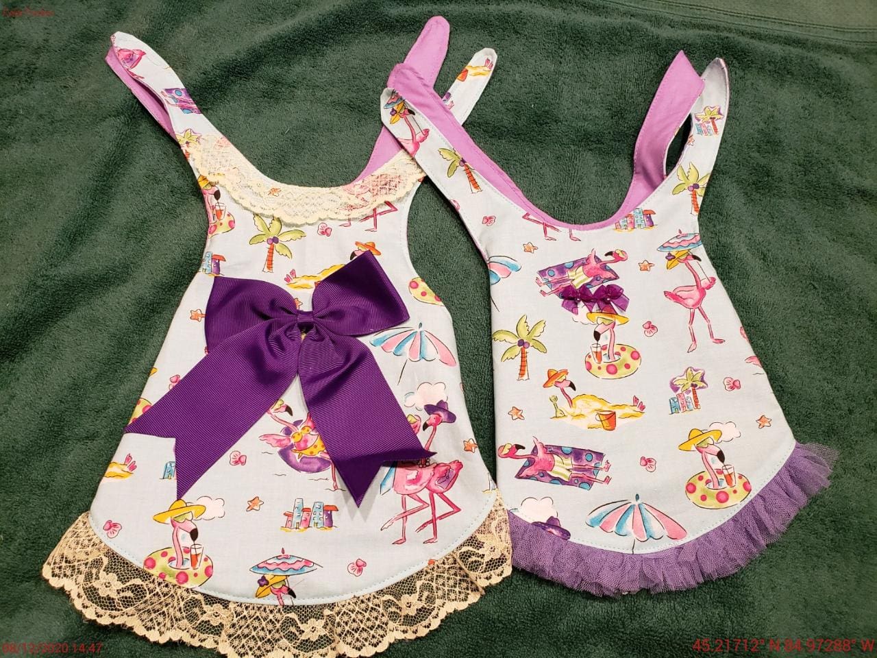 Two small aprons with a bow on them.