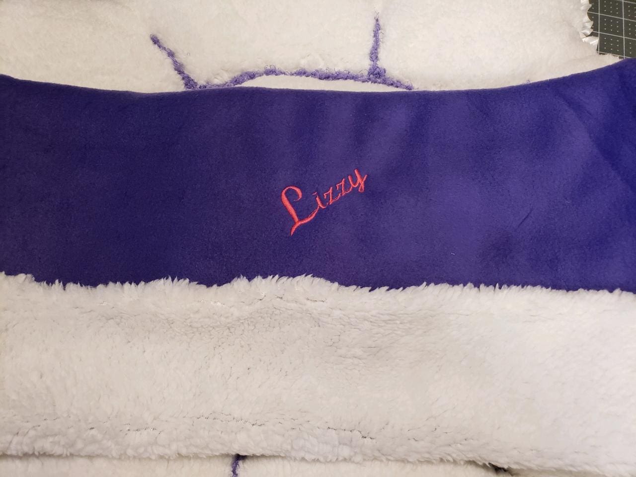 A close up of the name lucy on a blanket