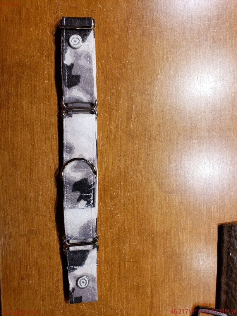 A wooden table with a black and white tie dye strap.