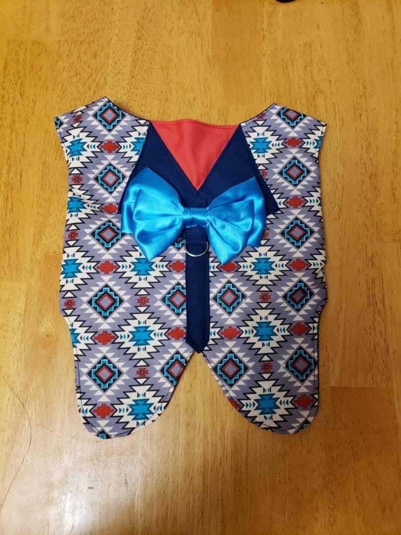 A bow tie is attached to the back of a vest.