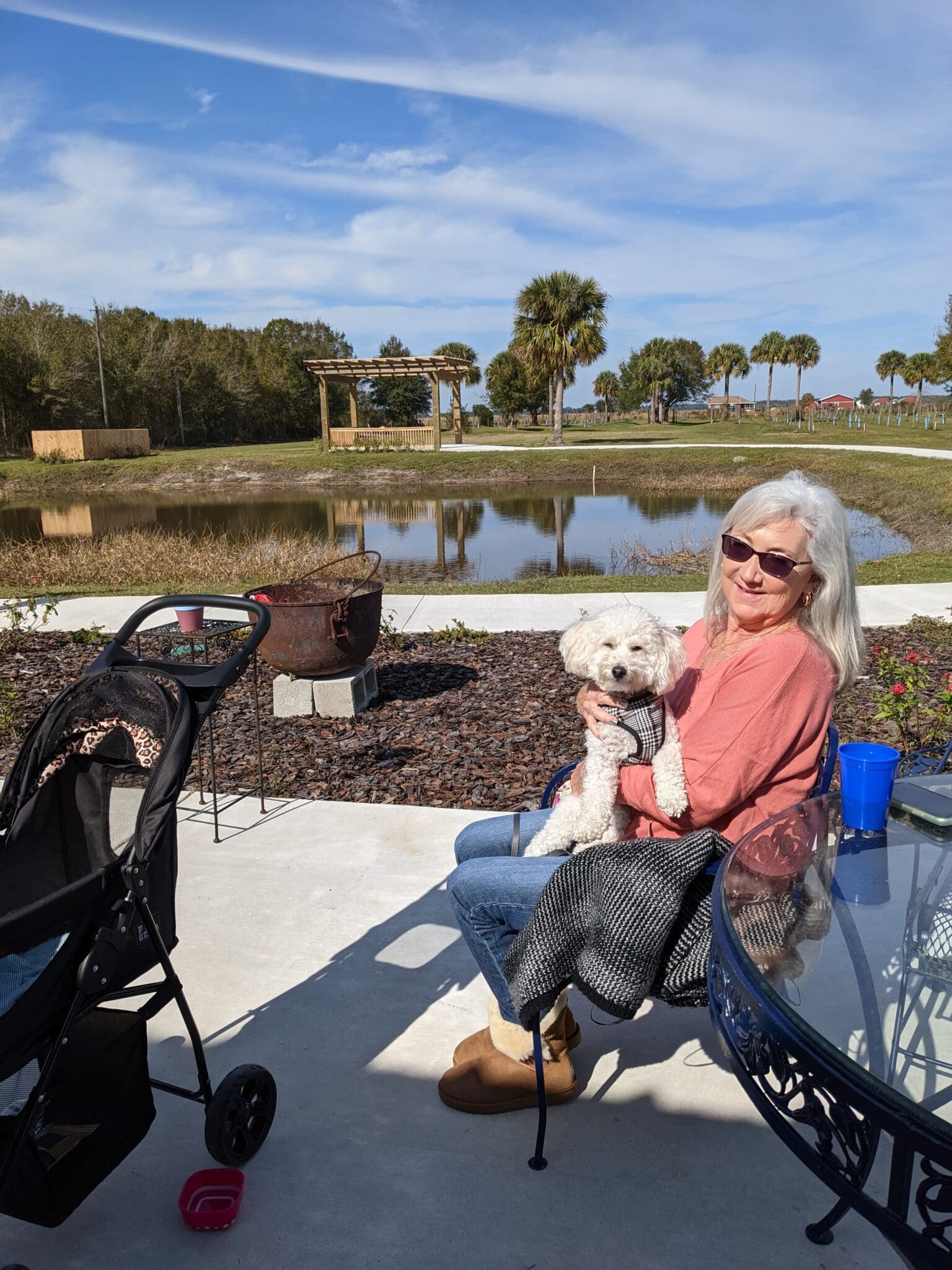 A woman sitting on the ground with her dog.