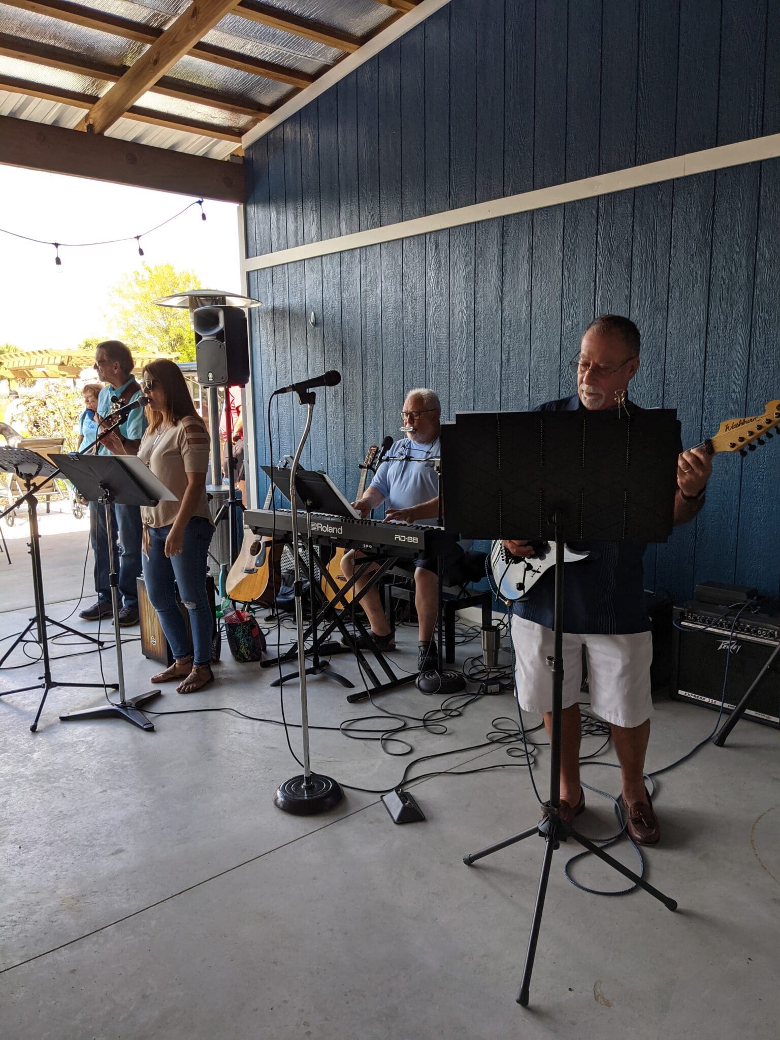 A group of people playing instruments in front of an audience.