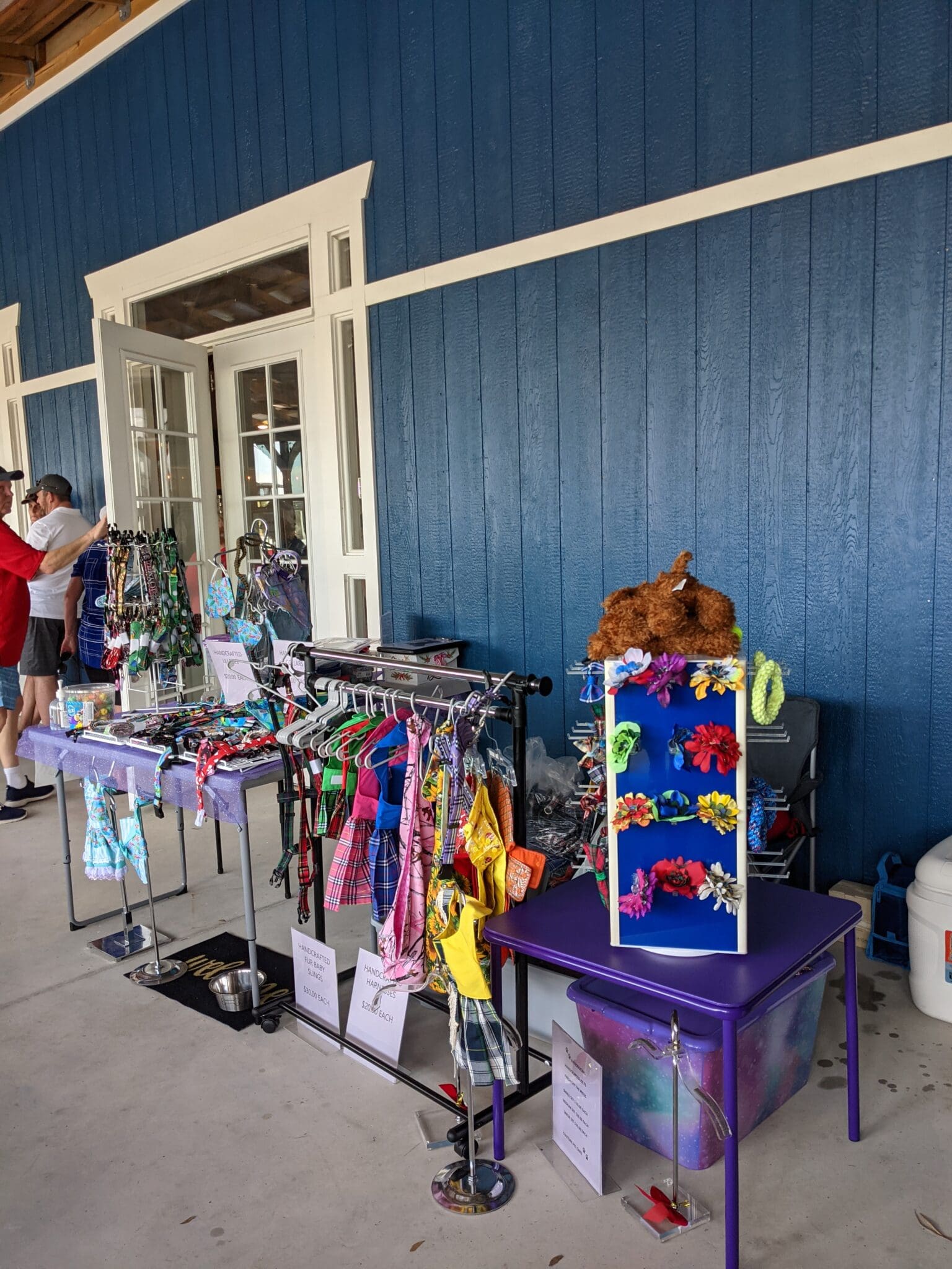 A woman looking at clothing and toys on display.