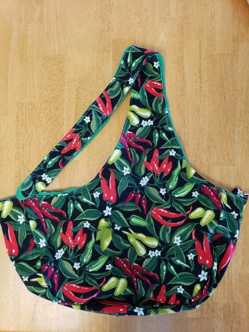 A bag with peppers on it sitting on the floor.