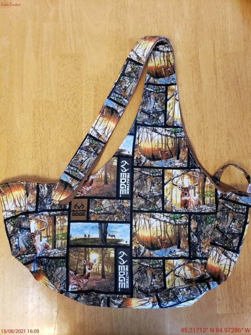 A bag with pictures of trees and people.