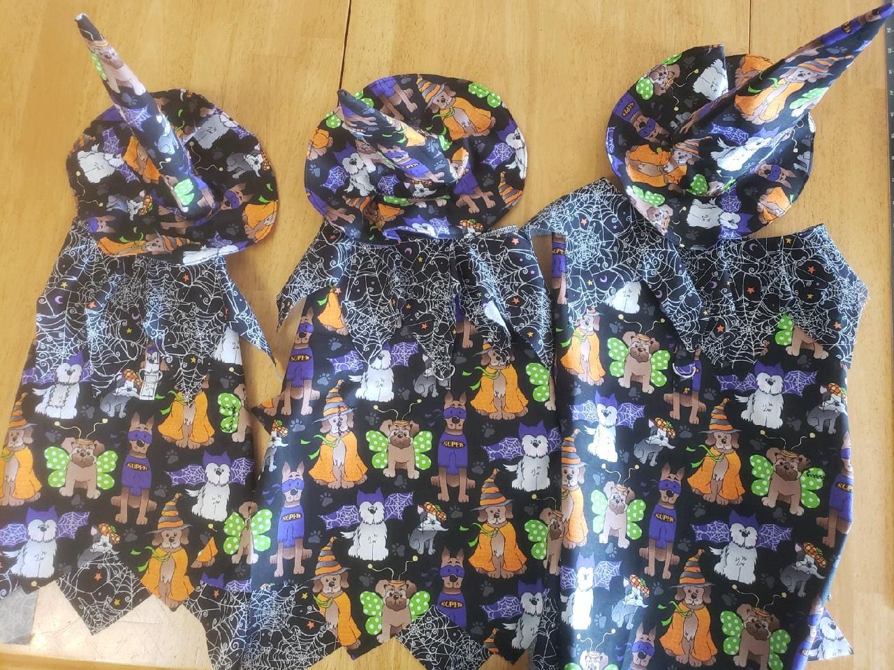 Three bags of halloween themed fabric sitting on a table.