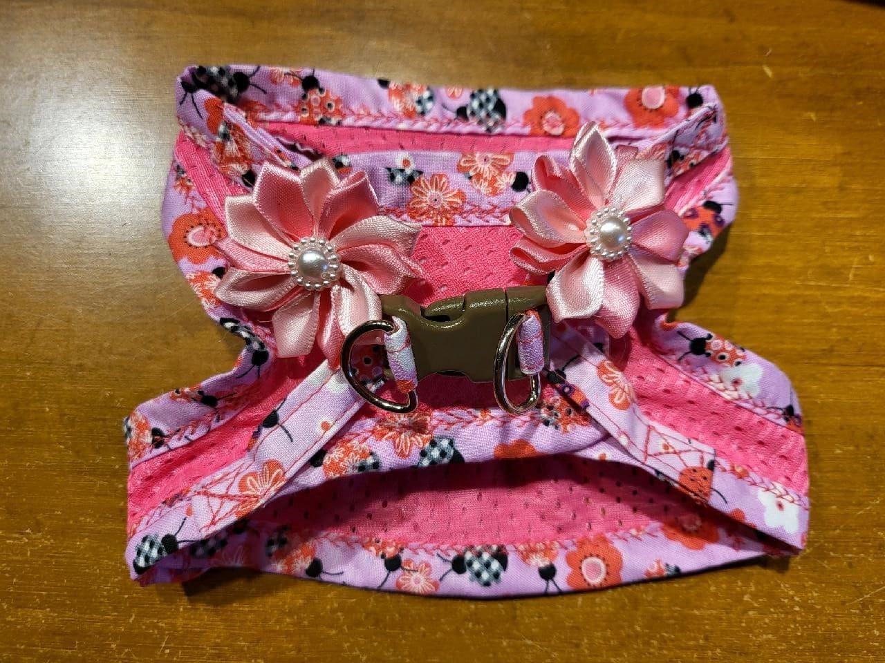 A pink purse with flowers on it