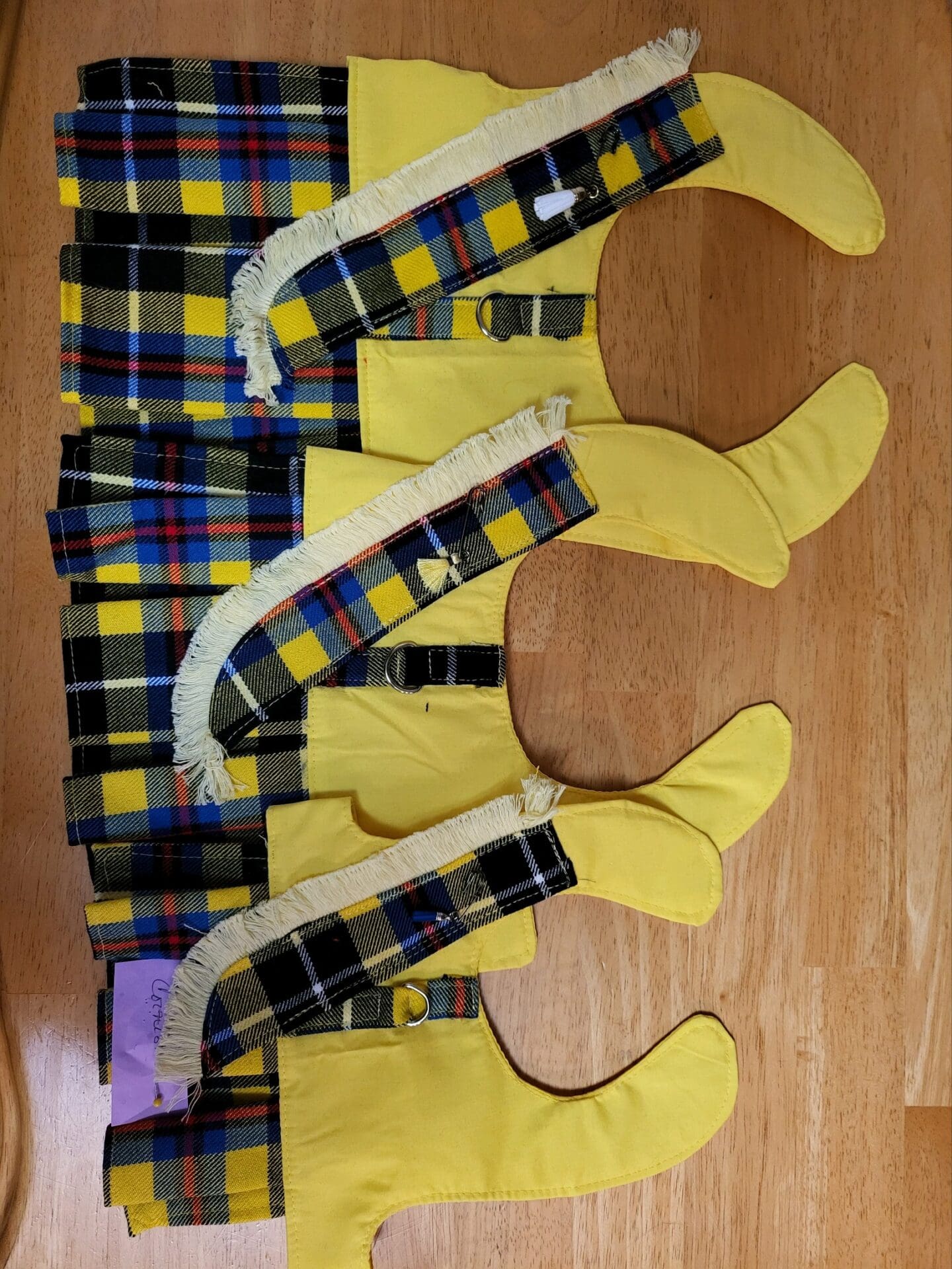 A wooden table with several pairs of yellow socks on it.