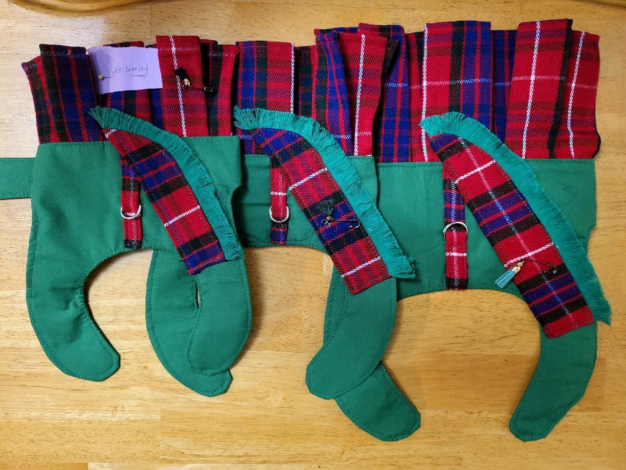 A group of green stockings with red and blue plaid on them.