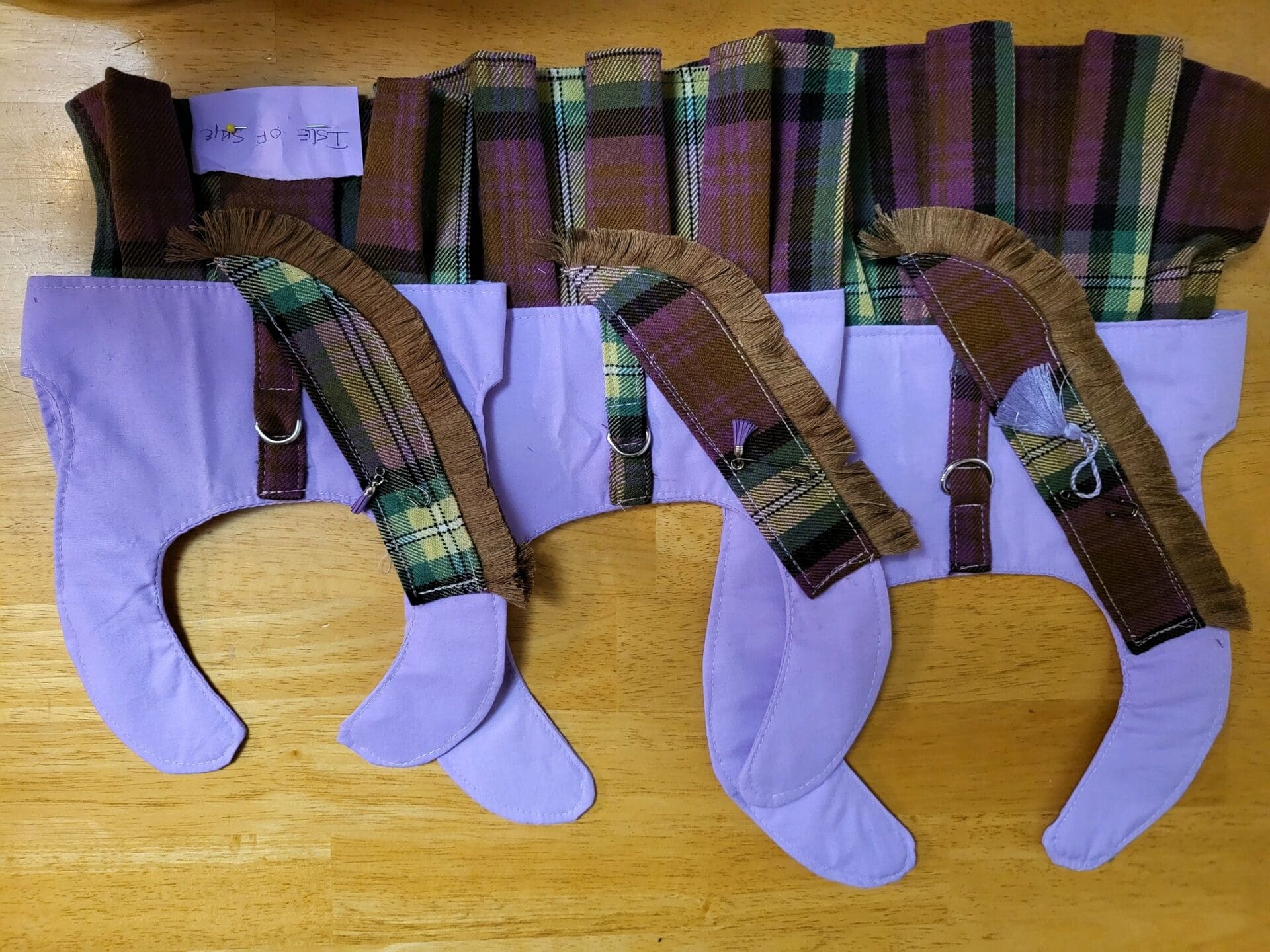 A wooden table with purple stockings and brown plaid.