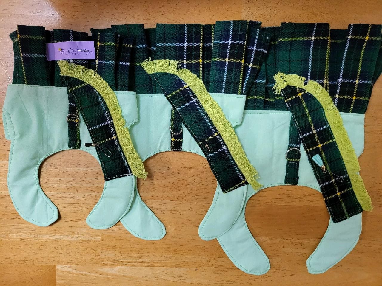 A row of green and yellow plaid stockings.