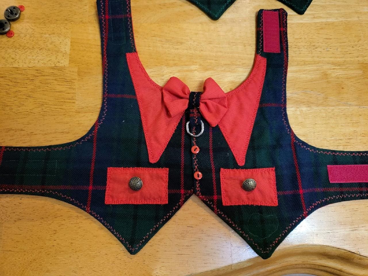 A vest with a bow tie and buttons on it.