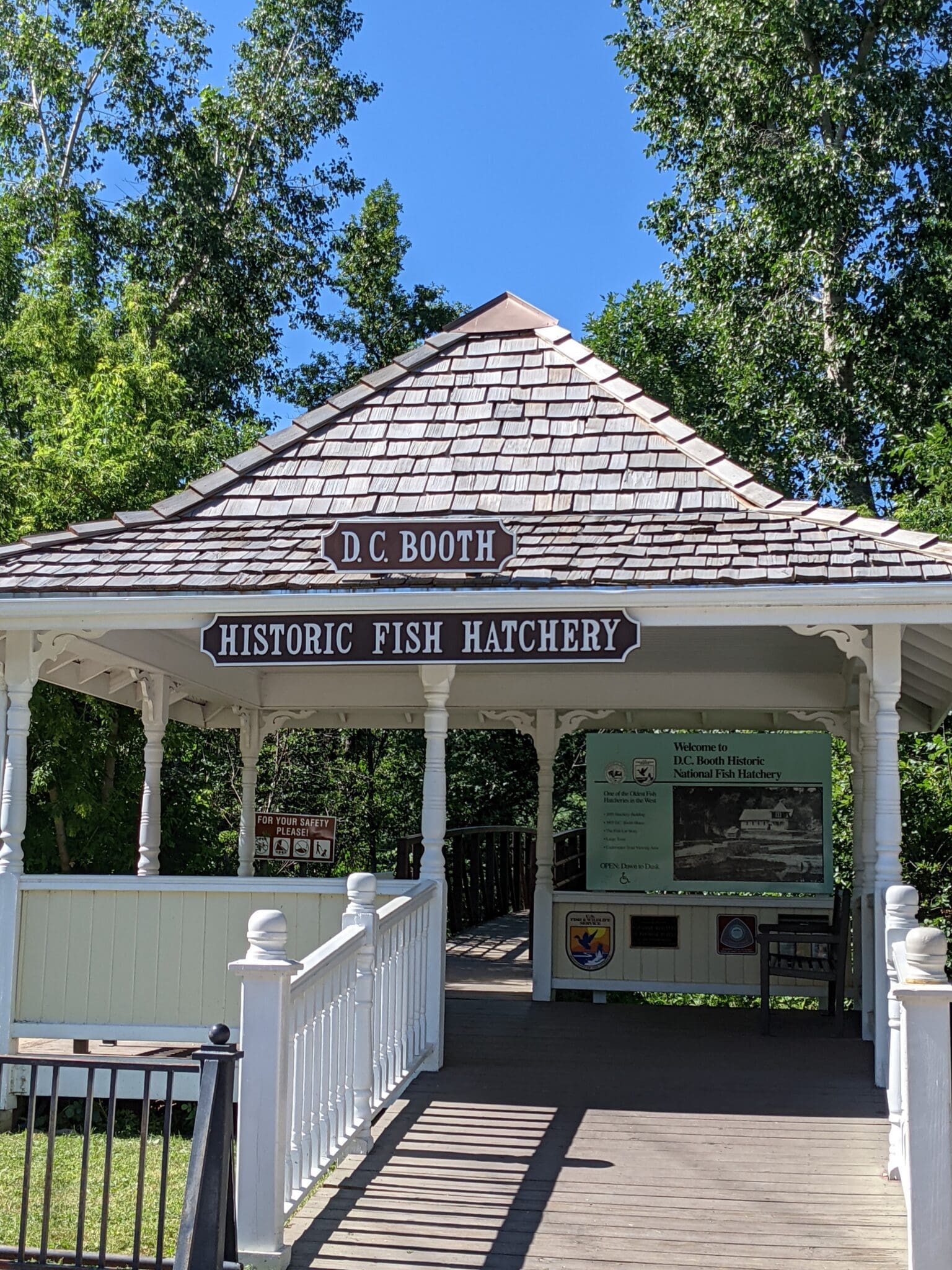 A gazebo with a sign that says historic fish hatchery.