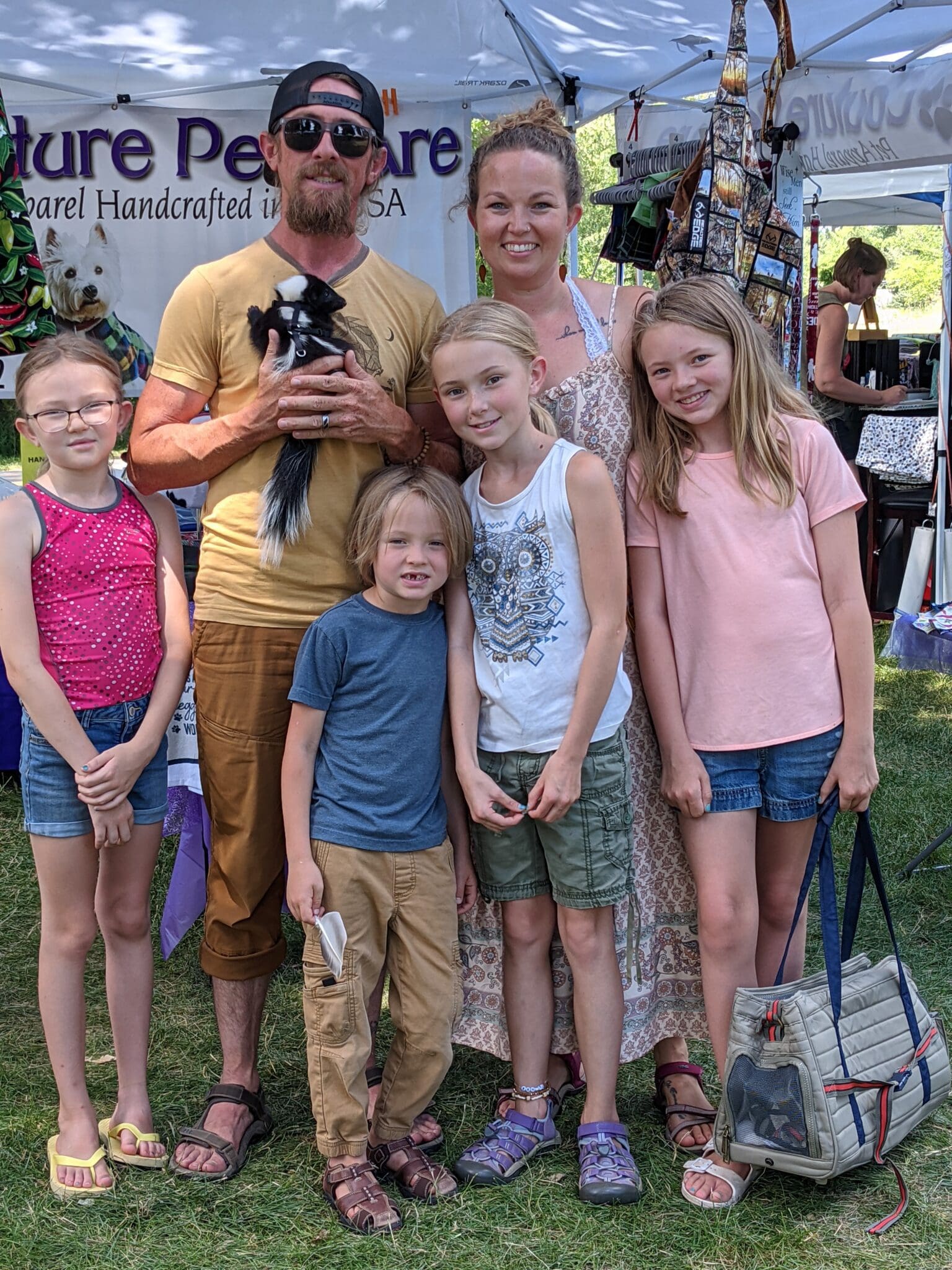 A family posing for a picture in the grass.