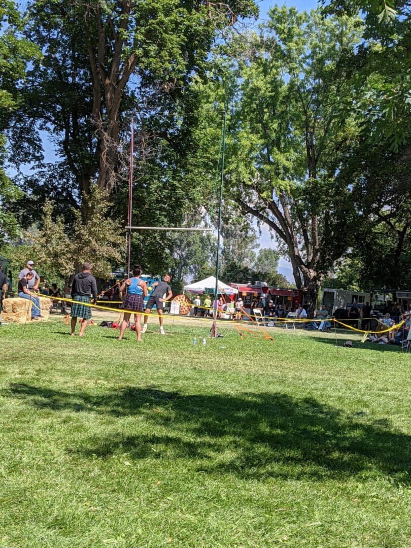 A group of people playing frisbee in the park.