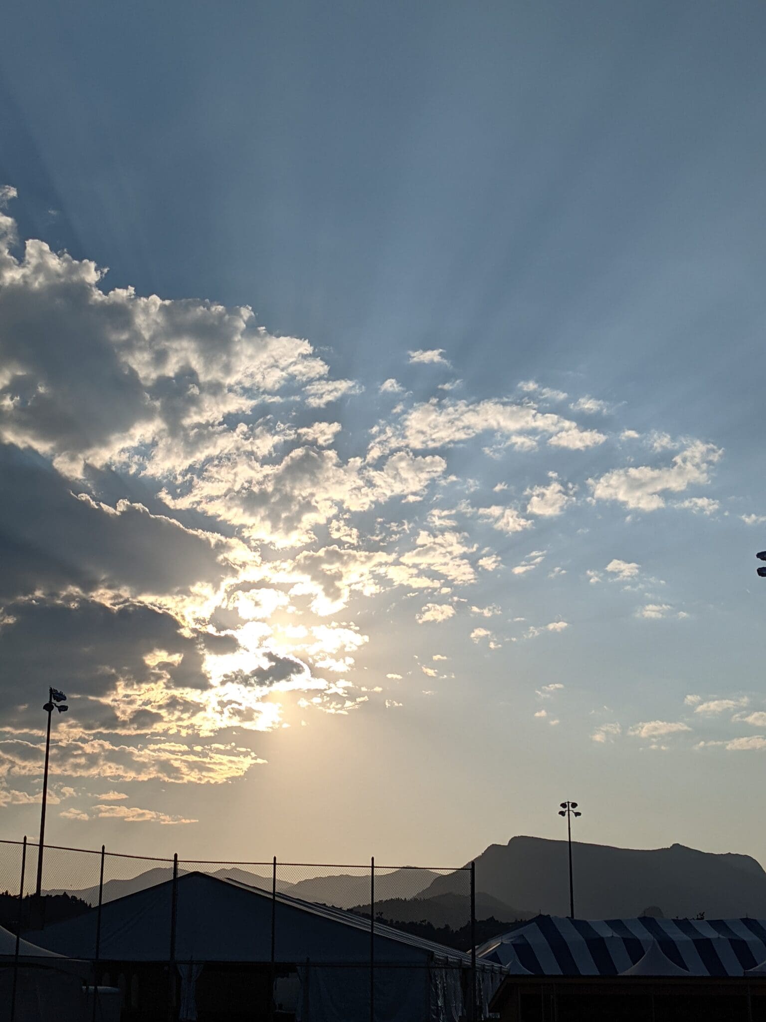 A view of the sun setting over mountains.