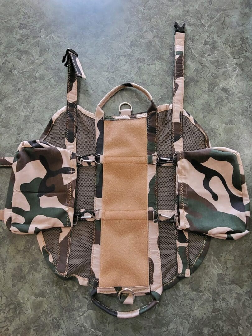 A camouflage bag with a tan strip on the front.