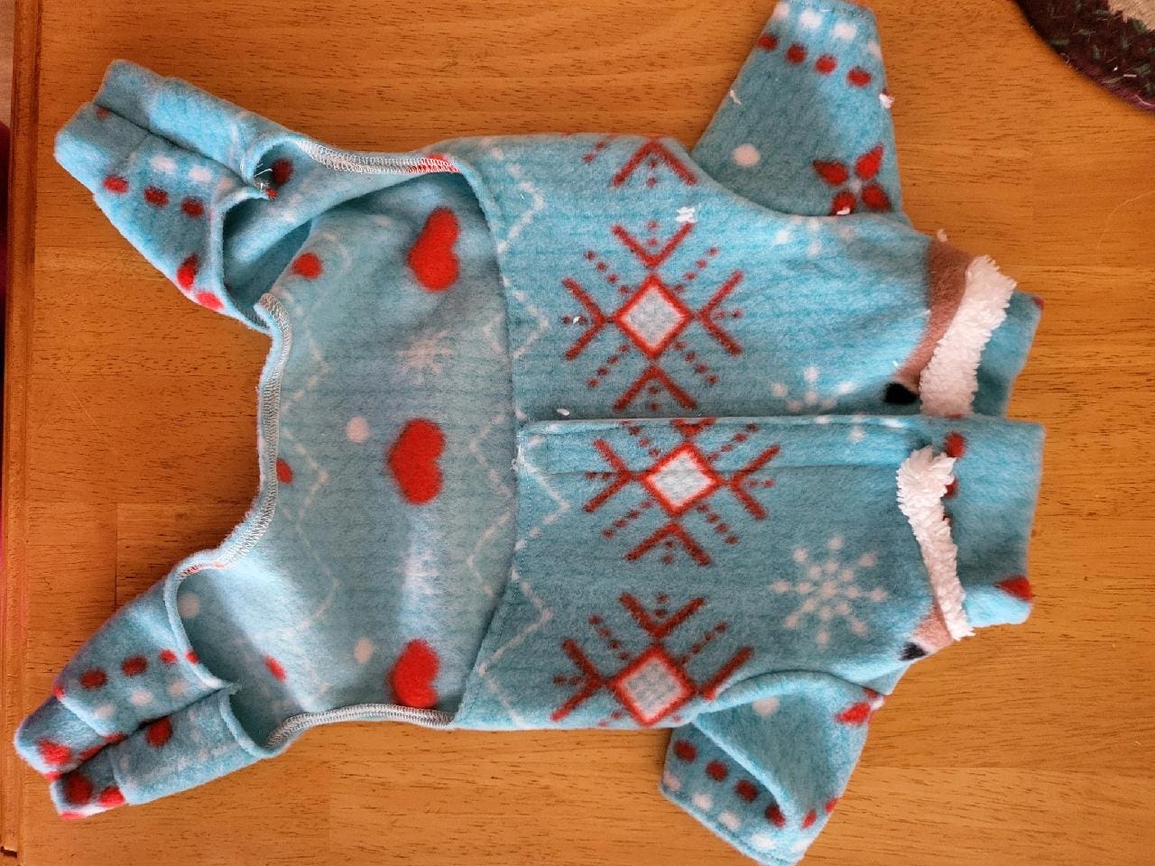 A blue cloth with red and white designs on it