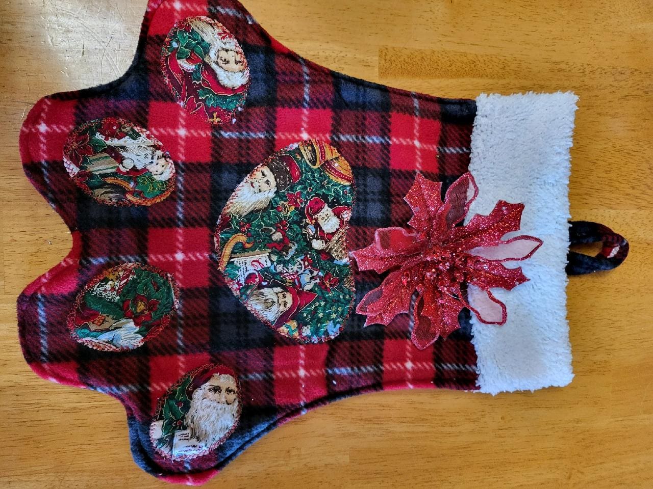 A christmas stocking with a red plaid design.