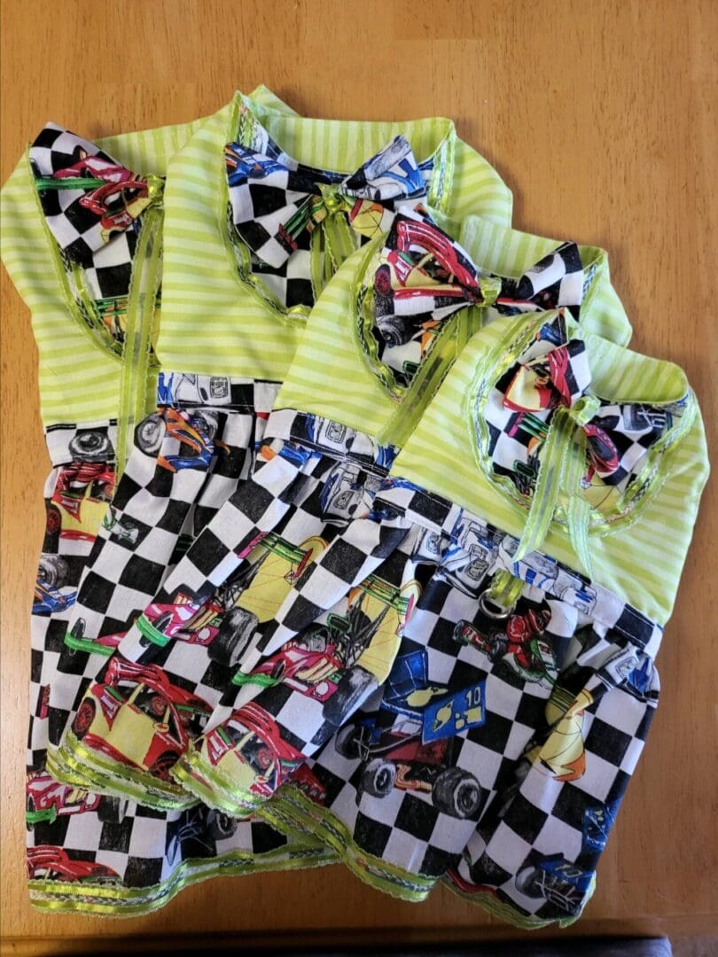 A group of checkered shirts with cars on them.