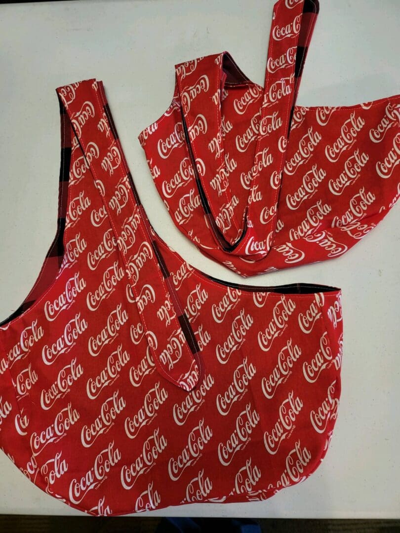 A red bag with the word coca cola on it.