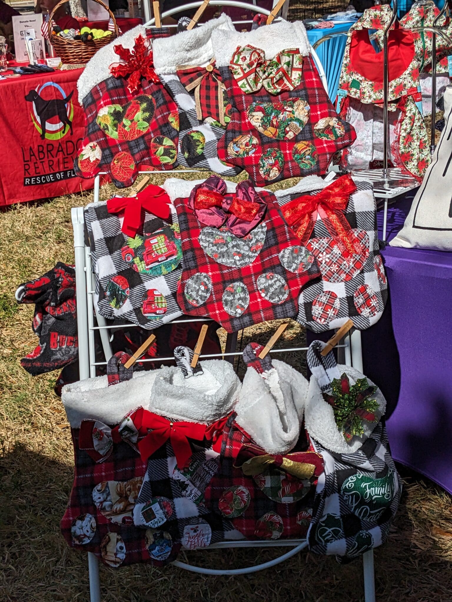 A display of various bags and purses on top of a table.