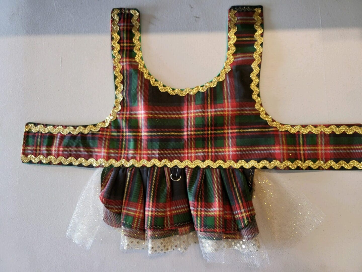 A red and green plaid dress with yellow trim.