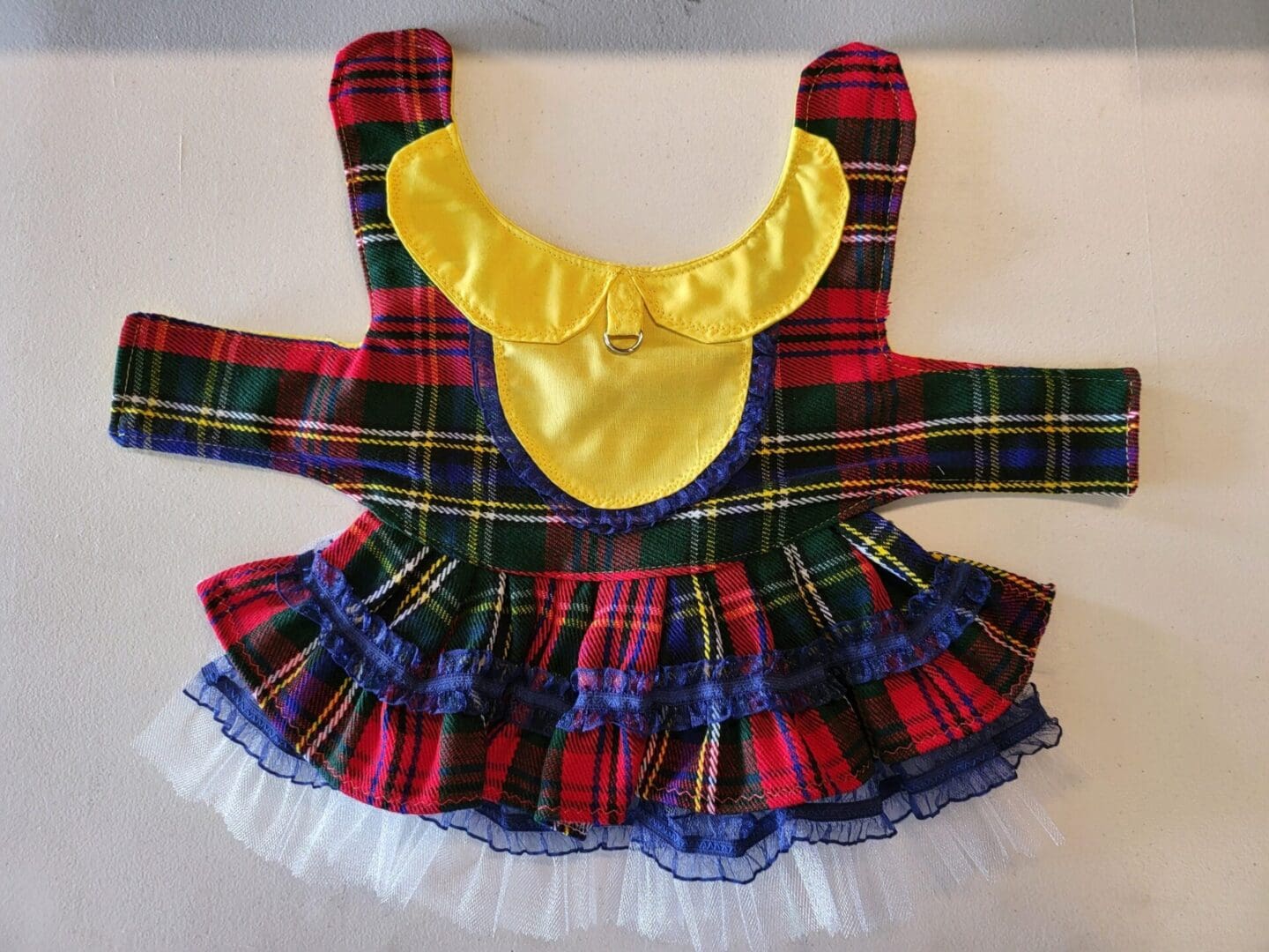 A dress that is made of fabric and has a bow on it.