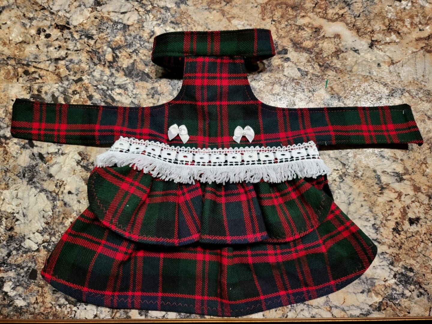 A red and green plaid dress with lace trim.